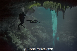 Divers in the cenote "The Pit" Mexico by Chris Miskavitch 